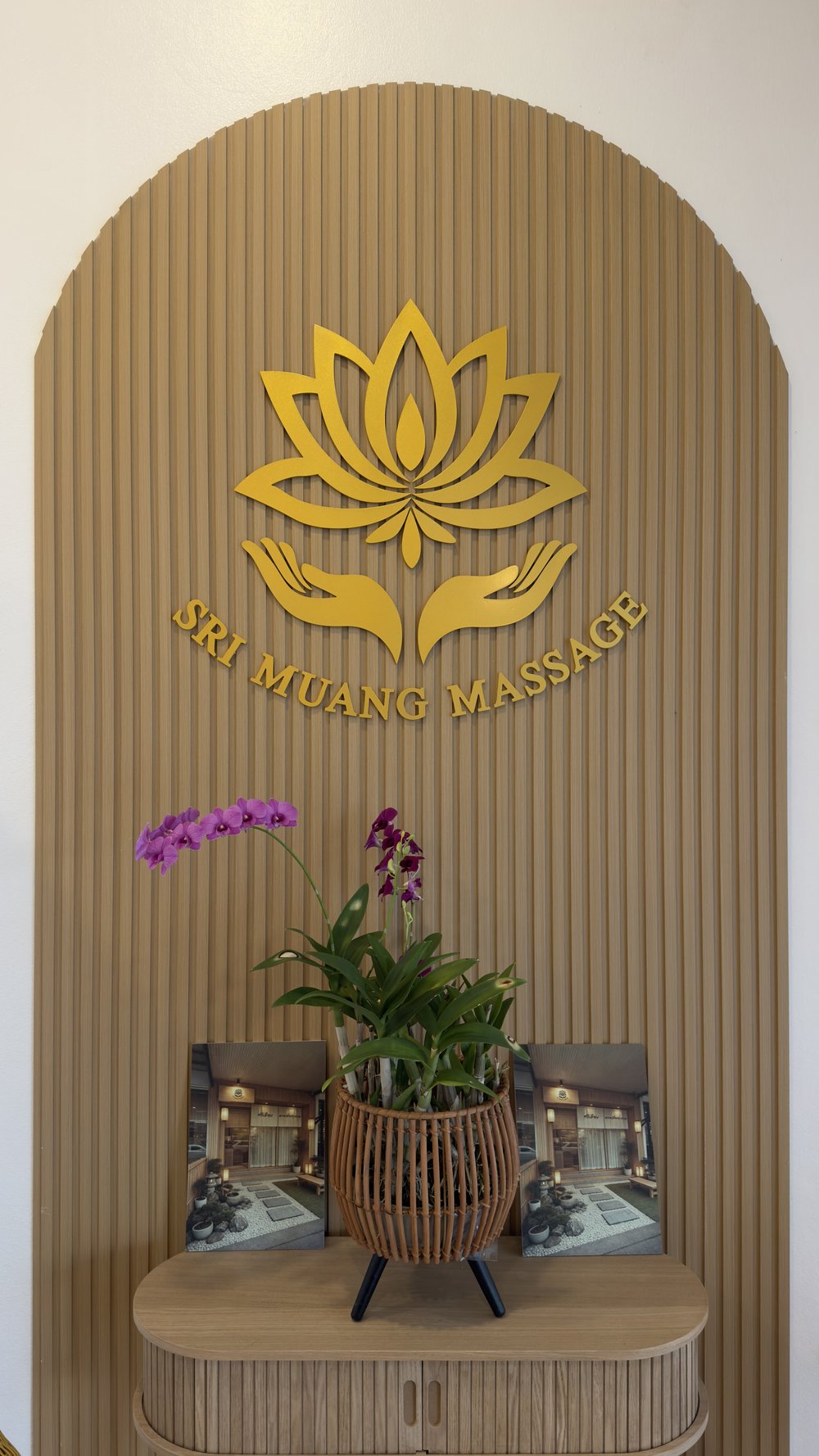 Sri Muang Massage lotus logo and orchid at the studio entrance